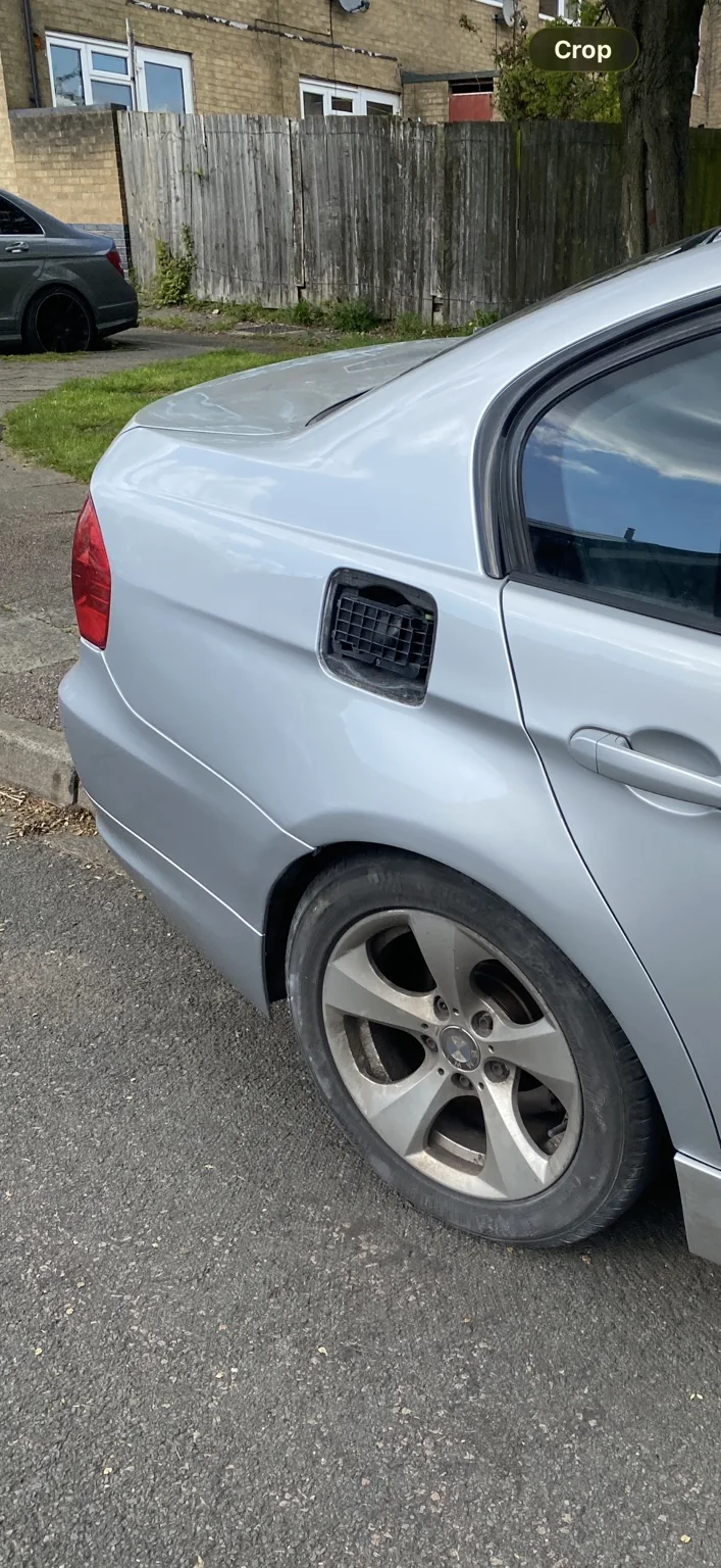 Silver BMW rear quarter panel after body repair
